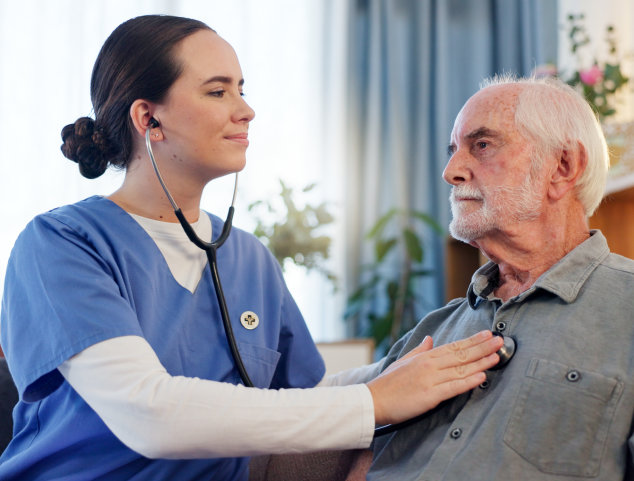 aide checking the health of the senior man